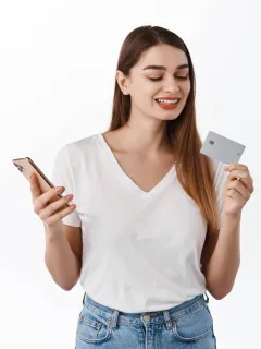 A woman holding her Mission Lane Visa.