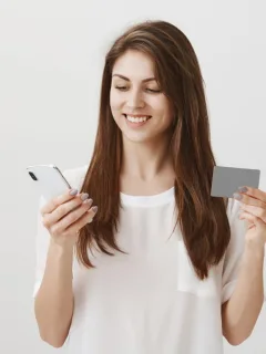 A woman using her QuicksilverOne Capital One.