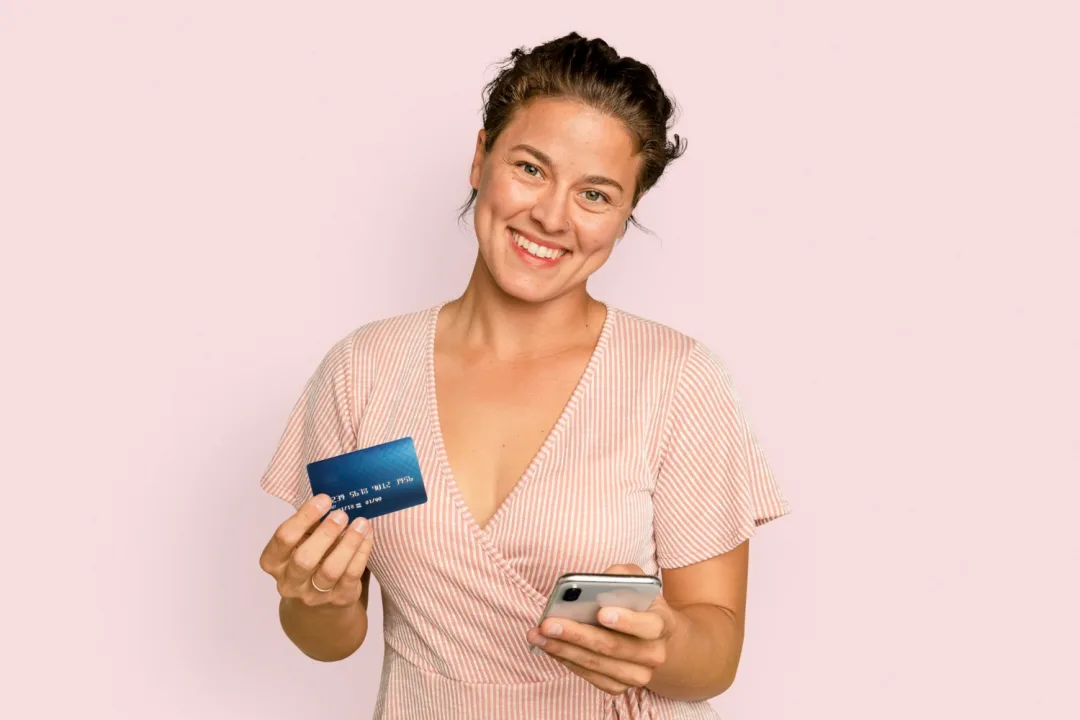 A woman holding her Discover it Cash Back Credit Card.