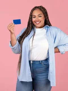 Woman holding her Bank of America Travel Rewards Credit Card.