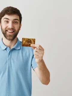 A man holding his Delta SkyMiles Gold American Express.