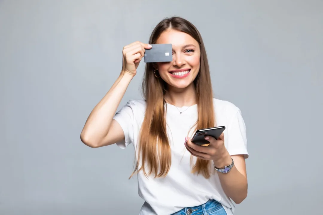 A girl holding her Simmons Visa.
