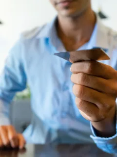 A man holding a INK Business Preferred credit card.
