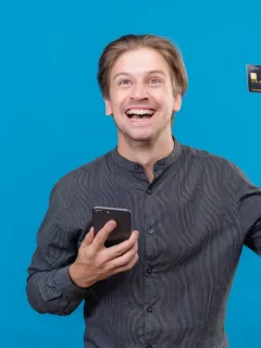 A guy holding a Southwest Rapid Rewards credit card.
