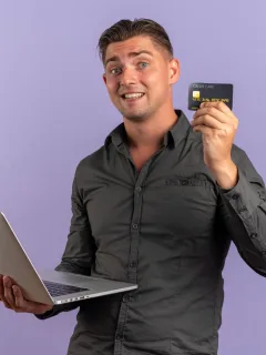 A guy holding his Bilt Mastercard.