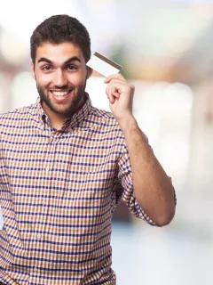 A guy holding a credit card and learning How to Get Credit Card CashBack.