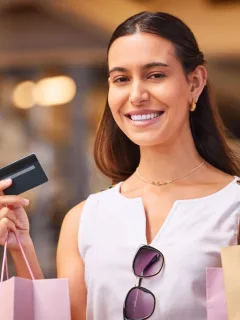Woman using and learning the Benefits of Using a Credit Card.