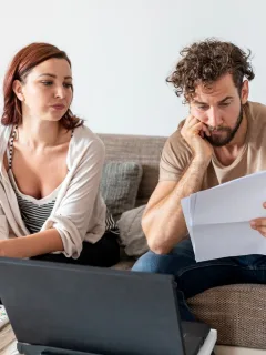 A couple learning When to Take Out a Personal Loan.