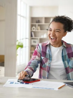 A happy woman learning How to Set Financial Goals.