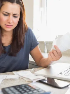 Woman thinking about refinancing car loan.