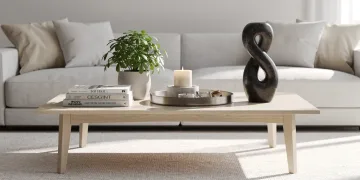 Elegantly styled coffee table with books, plant, and decor