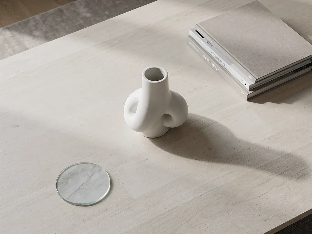 Minimalist coffee table with sculptural object and books
