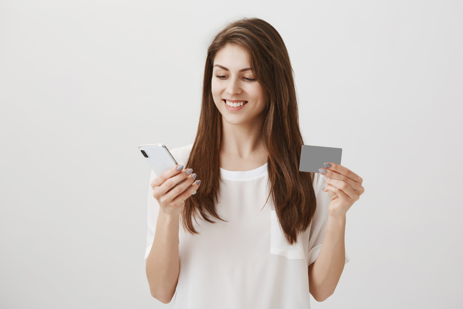 A woman using her QuicksilverOne Capital One.