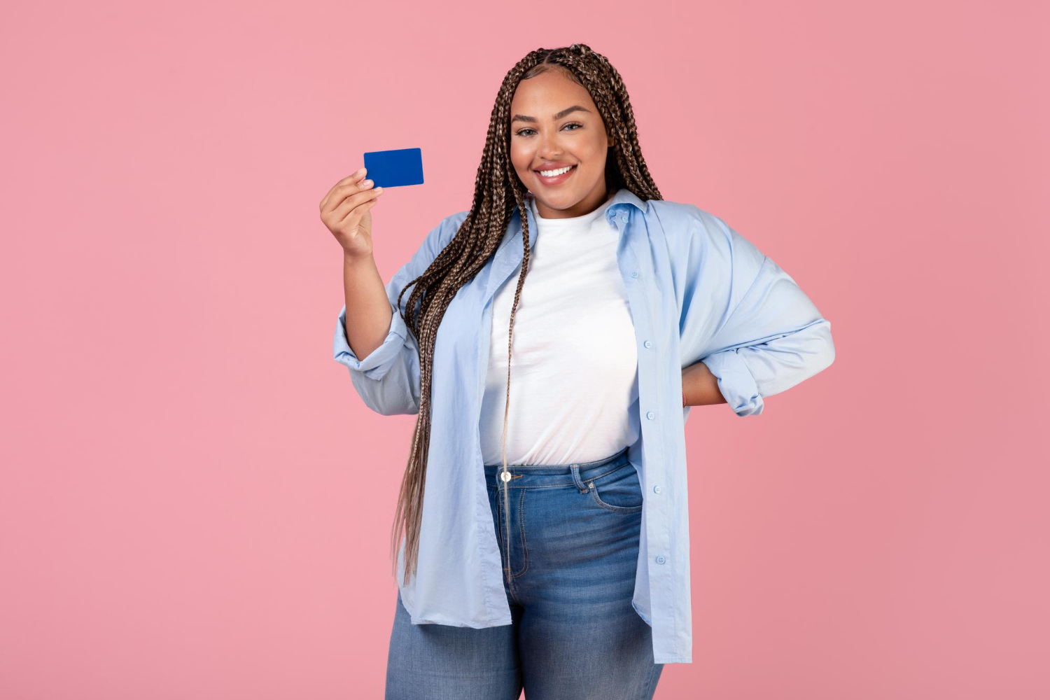 Woman holding her Bank of America Travel Rewards Credit Card.