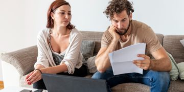 A couple learning When to Take Out a Personal Loan.