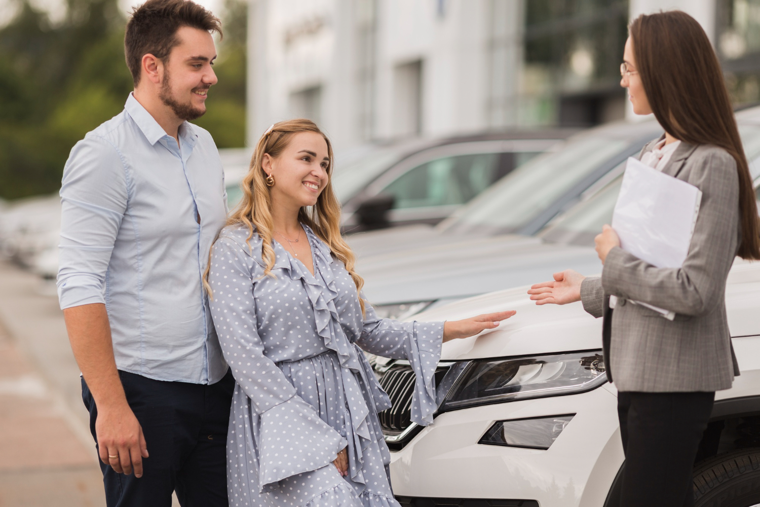 Couple choosing a car, being a pre-approved for a car loan