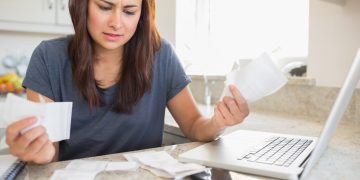 Woman thinking about refinancing car loan.