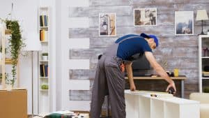 Man fixing furniture and home costs repair